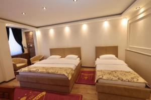 a bedroom with two beds and a chair at Agušević Home in Novi Pazar +54 photos