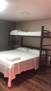 a bedroom with two bunk beds with white sheets at Aiezza Hotel in Barcarena +53 photos