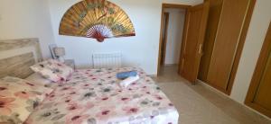 a bedroom with a bed with a floral comforter at Sueno de Peniscola in Peniscola