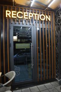 a revolving door to a restaurant with a sign on it at Agušević Home in Novi Pazar