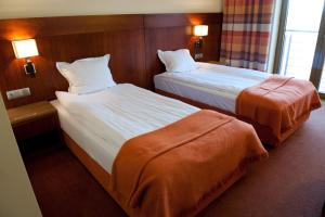 Postel nebo postele na pokoji v ubytování Hotel Amadeus