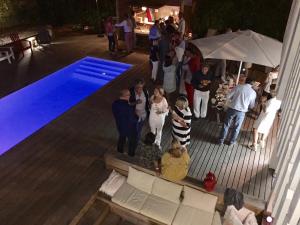 a group of people standing next to a swimming pool at Villa Lilas Cap-Ferret in Lège-Cap-Ferret +109 photos