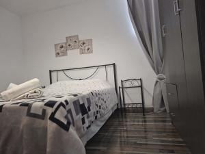 a bedroom with a bed and a cross on the wall at Simbas House in Leonidio