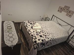 a bedroom with a black and white bed and a table at Simbas House in Leonidio +20 photos