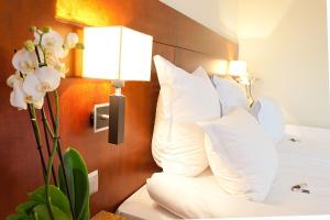 Postel nebo postele na pokoji v ubytování Hotel Amadeus