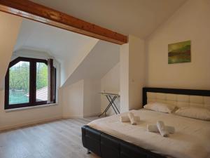 a bedroom with a large bed with a large window at Villa ENT in Bihać +45 photos