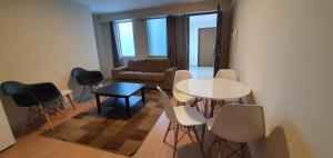 a living room with a table and chairs and a couch at Apartamentos San Martín in San Antonio
