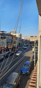 a city street with cars parked on the road at Apartamentos San Martín in San Antonio