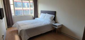 a small bedroom with a bed with a window at Apartamentos San Martín in San Antonio