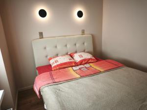 a bedroom with a bed with two pillows on it at Panorama View Suite in Jelgava