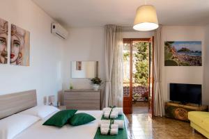 a bedroom with a bed and a living room at Taormina Matthome in Taormina