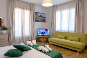 a living room with two beds and a couch at Taormina Matthome in Taormina