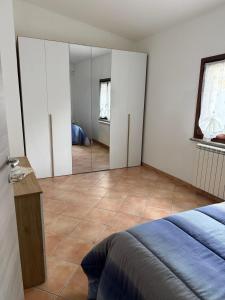 a bedroom with a bed and a large mirror at Casotta Luca in Vigevano