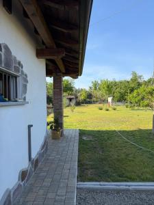 a porch of a house with a field in the background at Casotta Luca in Vigevano