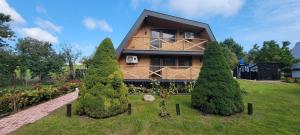 a house with three trees in front of it at Duchniczowe in Prusie