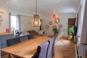 a living room with a wooden table and a couch at B&B Angelbeeck in Afferden