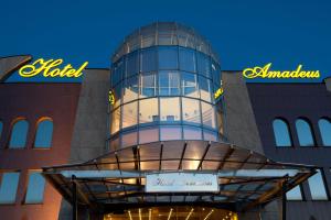 a building with a clock on the side of it at Hotel Amadeus in Wodzisław Śląski