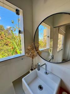 a bathroom with a sink and a mirror at Serra do Cipó Casa Baru in Santana do Riacho +22 photos