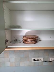 a cabinet with a stack of plates in a kitchen at Geräumige Monteurwohnung in Mistelbach