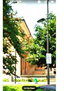 a street light in front of a building with trees at Fantasy House in Cremona