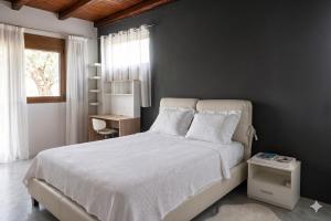 a bedroom with a white bed and a window at Apartment Vergina in Áyioi Dhéka