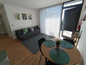 a living room with a table and a couch at Refúgio D'Aguiar in Aguiar da Beira
