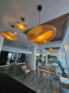 a living room with several lights hanging from the ceiling at Infinity Bay Suites in Puerto Galera