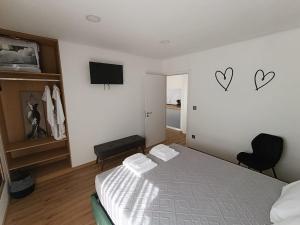 a bedroom with a bed and two hearts on the wall at Refúgio D'Aguiar in Aguiar da Beira