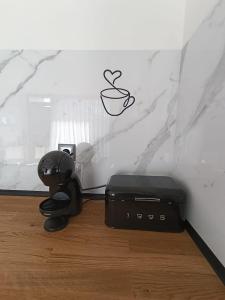 a coffee machine sitting on the floor next to a wall at Refúgio D'Aguiar in Aguiar da Beira