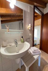 a bathroom with a sink and a mirror at Welcome Traveller Caorsa Rooms in Cavaion Veronese