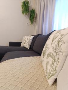 a couch with a blanket and a pillow on it at Studio 35 - Modern & Cozy Studio in Chalandri City Center in Athens