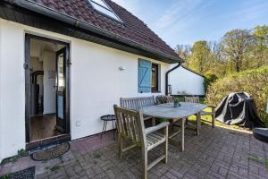 a patio with a wooden table and chairs at Kleines Schleihaus Lorenz in Boren