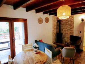 a living room with a wooden table and chairs at La grangette in Ajoux