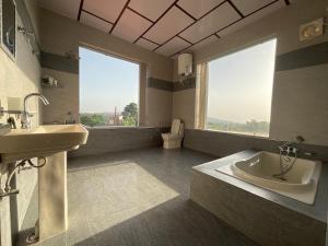 a large bathroom with a tub and a sink at Casa Ramona Luxury Villa With Hot Tub Near Dharamshala Palampur in Pathyar
