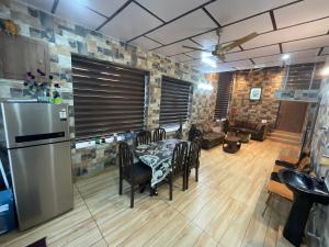 a kitchen with a table and chairs and a refrigerator at Casa Ramona Luxury Villa With Hot Tub Near Dharamshala Palampur in Pathyar +31 photos