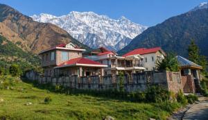 a row of houses on a hill with mountains in the background at Casa Ramona Luxury Villa With Hot Tub Near Dharamshala Palampur in Pathyar
