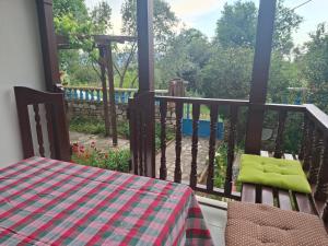 a balcony with a table and a view of a yard at Villa İkiz in Ula +3 photos