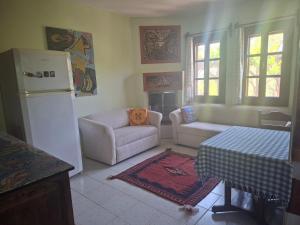 a kitchen with a refrigerator and a couch and a table at Villa İkiz in Ula