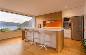 a kitchen with a counter and a large window at Fifteen by Amazing Accom in Queenstown