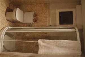 a towel rack in a bathroom with a tv on the wall at Areeta Etxea - Espejo in Espejo +19 photos
