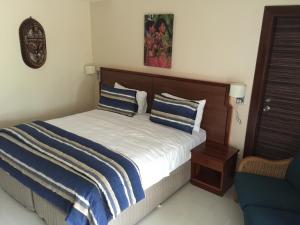 A bed or beds in a room at Madang Resort