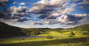 a large field with a lake and a cloudy sky at Areeta Etxea - Espejo in Espejo