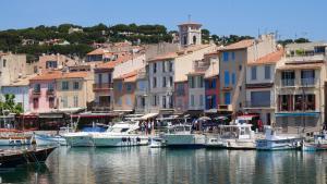 a group of boats are docked in a harbor at L'Âme Bleue in Cassis
