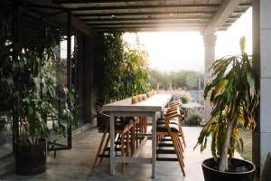 a table and chairs on a patio with plants at Casa X in San Miguel de Allende