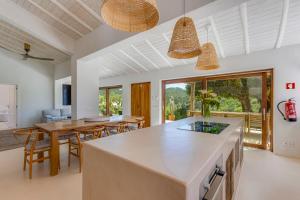 an open kitchen and dining room with a table and chairs at Quinta Javali in Aljezur