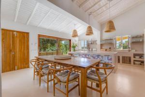 a large kitchen with a wooden table and chairs at Quinta Javali in Aljezur +39 photos