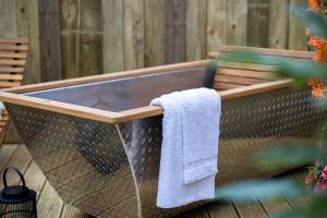 a hammock with a towel hanging on it at Da Vinci's Den in North Tawton
