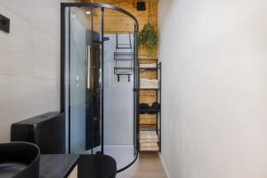 a glass shower in the corner of a room at Try and Try in Cunit
