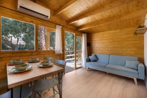 a dining room with a blue couch and a table at Try and Try in Cunit