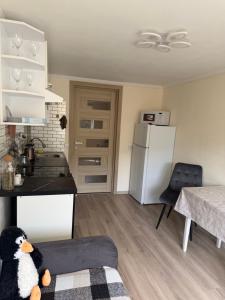 a kitchen with a refrigerator and a table in a room at U-Home in Verkhovyna